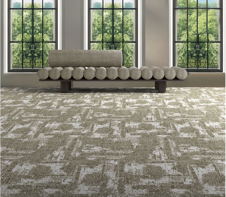 Moving distressed carpet tile with abstract directional markings in office